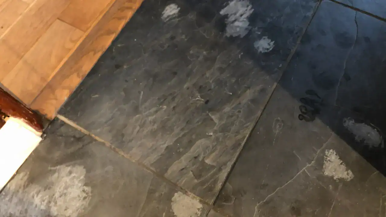 Hand diamond sanding block removing grout haze from slate